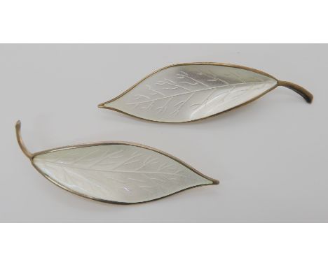 A pair of silver and white enamel leaf brooches by David Andersen Condition Report: Not available for this lot