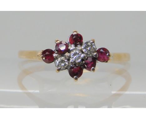 A 9ct gold ruby and diamond cluster ring, size W1/2, weight 1.9gms Condition Report: Available upon request