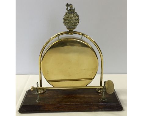 A vintage brass table dinner gong.