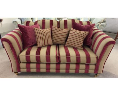 A reproduction Victorian 2 seater sofa in red & gold striped upholstery with wooden and brass legs. In excellent condition.