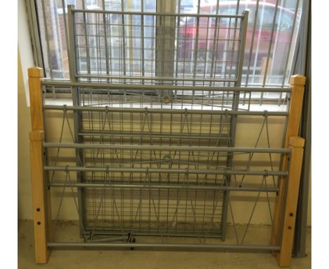A 4' 6" bed with light wood posts and grey metal head and foot boards and rails.