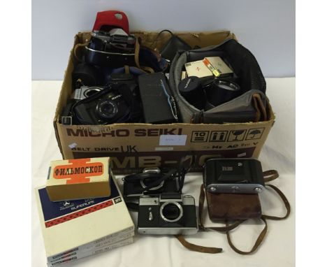 A large box of cameras & accessories to include Olympus OM10, Zenit-E, Yashika FR, Praktica Super TL & LTL 3 camera bodies, 4