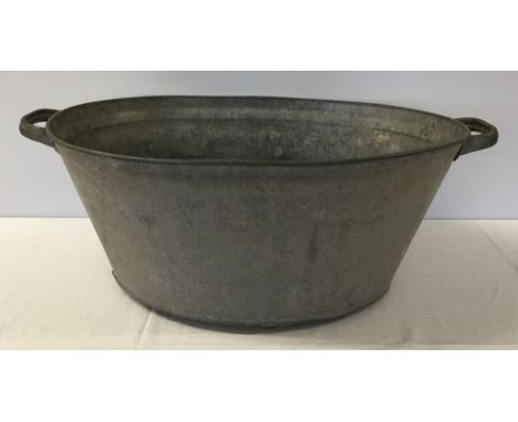 Vintage galvanised metal bath with handles. Approx 55cm x 40cm x23cm high.