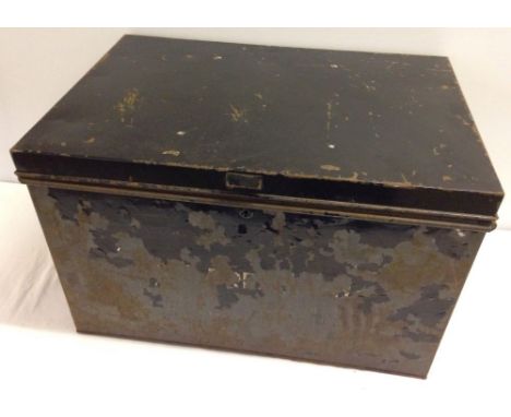 A vintage black tin travelling trunk.