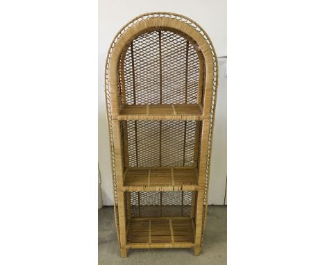 A rattan 3 shelf unit with curved top.