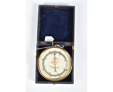 A CASED COMPENSATED HANGING ANEROID BAROMETER, this is made of brass and has a white dial with black numbers and lettering, i