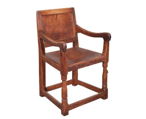 ROBERT 'MOUSEMAN' THOMPSON (1876-1955): AN ENGLISH OAK CARVER ELBOW CHAIRthe slung leather seat above a simple panelled back,