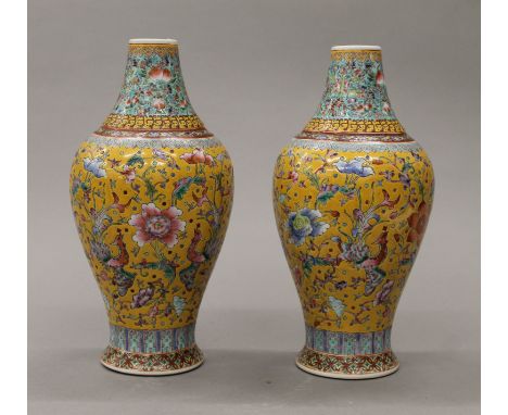 A pair of Chinese porcelain yellow ground famille rose vases, hand painted with flowers, peaches and phoenix blue with Daogua