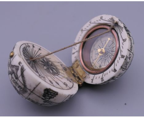 A bone compass formed as a globe. 4 cm high.