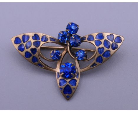 An Art Deco style blue enamel and blue stone set brooch. 3.5 cm wide.