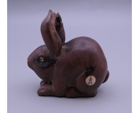 A wooden netsuke formed as a rabbit. 5 cm high.