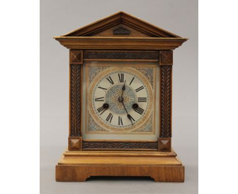A Victorian walnut mantle clock. 32.5 cm high.