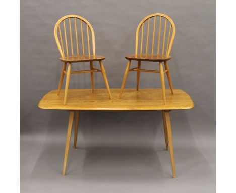 A blonde Ercol dining table and set of six Ercol chairs. The table 155 cm long.