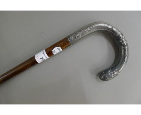 A silver handled walking stick. 89 cm long.