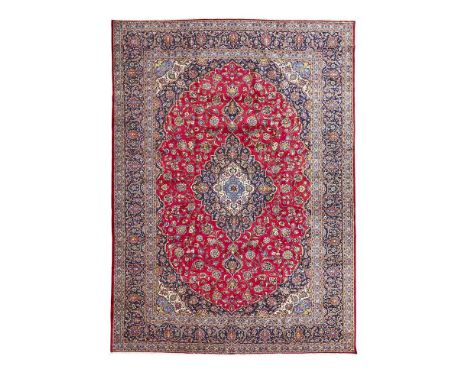 the red field with indigo and ivory medallion, similar spandrels, within indigo palmette and arabesque vine border435 x 316cm