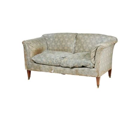 with a slightly arched back, outswept arms, and padded seat raised on square tapering legs with brass caps and castors, the l