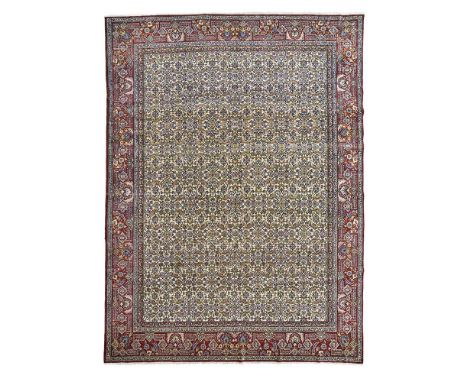 the ivory field with allover herati pattern, within red palmette and strapwork border392cm x 312cm