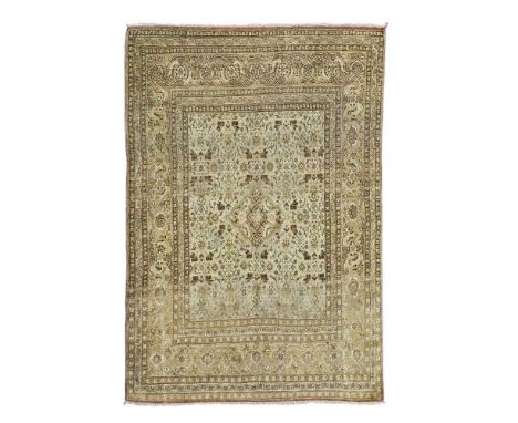 the creamy brown field with lozenge medallion, within light brown palmette and vine border171cm x 127cm