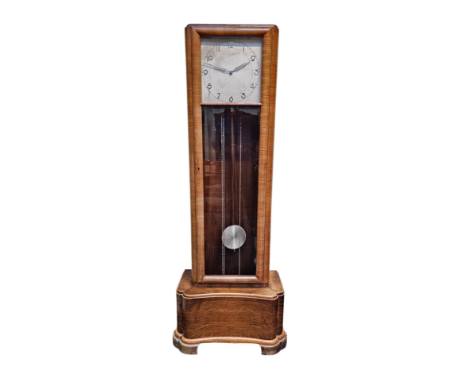 A French Art Deco longcase clock having three train striking movement having a square dial with Arabic numbers over a glazed 