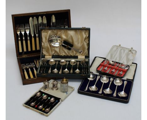 An oak cased set of twelve fish knives and forks, each with silver collar, a pierced silver salt and pepper and a small quant