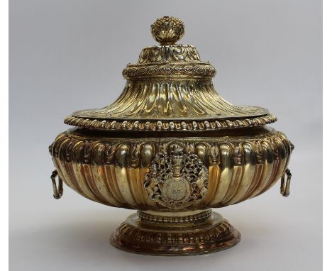 A large silver gilt bowl and cover on pedestal foot. The knop in the form of a pomegranate with cherub mask handles. Engraved
