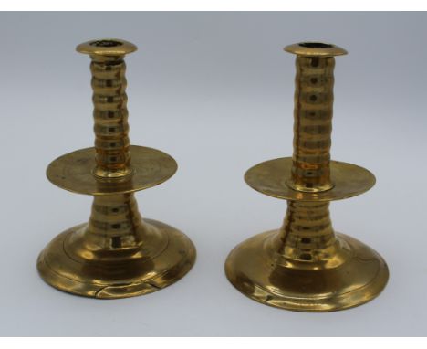 A near pair of Charles II brass ' trumpet base' candlesticks. Each with ribbed column and drip pan on a spreading foot. 14cm 