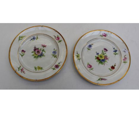 A pair of Royal Worcester plates with floral designs, marked 2/932