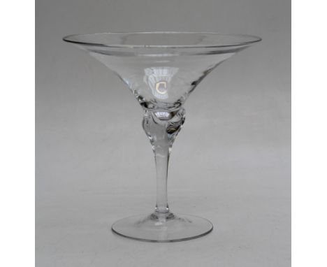 A large, late 20th century trumpet form clear glass vase. Raised on an organic column and spreading foot. 34cm high