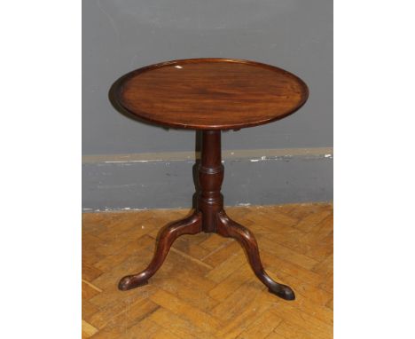 A George III mahogany snap top table, the circular top over a turned column and tripod cabriole legs, diameter 61cm