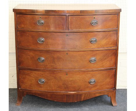 An early Victorian mahogany chest of drawers having two short and three long drawers fitted with later brass handles, raised 