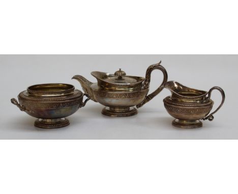 A sterling silver three piece tea service by Paul Storr. Gadroon decorated pedestal feet with matching baluster bodies. The s