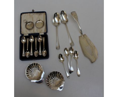 A collection of sterling silver to include a pair of 1777 serving spoons London TW, shell butter dishes, cased teaspoons, wat