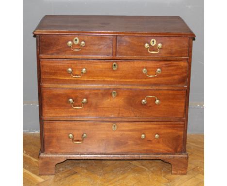 A George III walnut and pine chest having two short and three long drawers fitted with swan neck handles, raised on bracket f