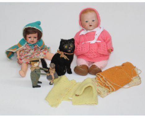 A Schuco clockwork dancing sailor and child, 13cm high, a me-owing clockwork cat, a German composition doll and an Armand Mar