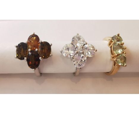 Three 20th century 10 carat gold gem-set rings: a floral design tourmaline and topaz dress ring, a white stone floral design 