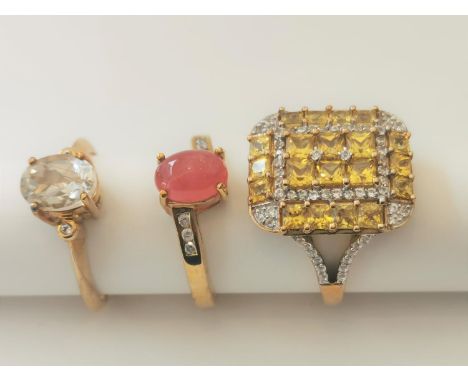 Three 20th century 9 carat gold gem-set rings: a ruby and diamond cross over ring, a Citrine and cubic zirconia rectangular g