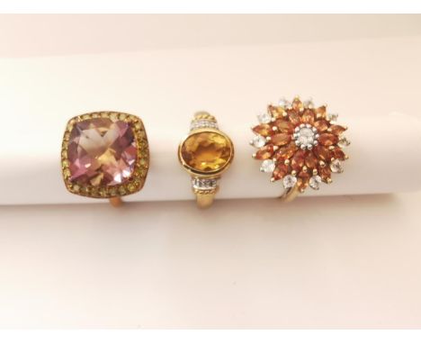 Three 20th century 9 carat gold gem-set rings: an orange and white sapphire sun design dress ring, an ametrine and yellow dia