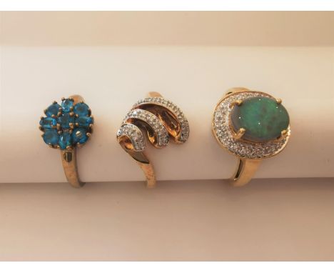 Three 20th century 9 carat yellow gold gem-set rings: a sugar treated opal and diamond cluster ring, a spiral shell form diam