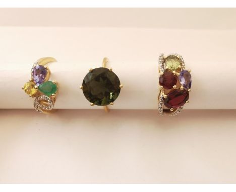 Three 20th century 10 carat gold gem-set rings: a green stone solitaire ring, a dress ring set with tourmaline, diamond, peri