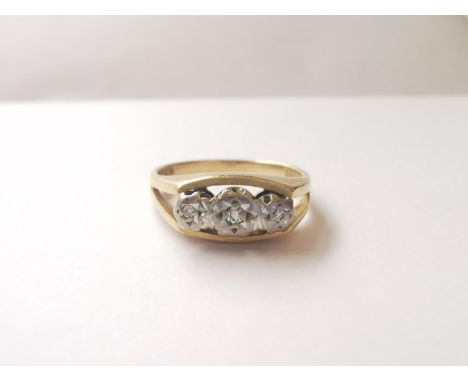 An 18ct yellow gold and white gold three stone diamond ring, set with three round brilliant cut diamonds with a combined appr