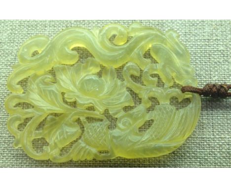 A TRANSLUCENT JADE PENDANT Finely carved with a dragon and flower.  