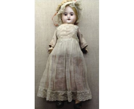 S.F.B.J., PARIS An early 20th Century Bisque headed doll, dressed in period clothing with bonnet and impressed 'S.F.B.J., Par