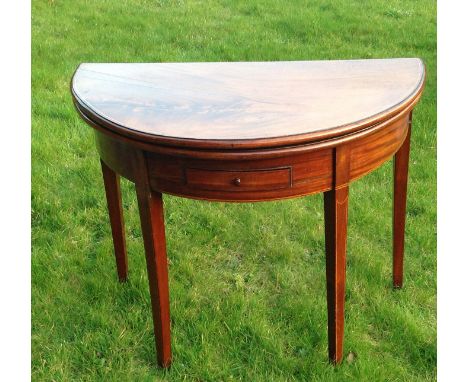 A GEORGE III PERIOD MAHOGANY FOLD OVER CARD TABLE Of unusual oval form, the flame top unfolding to reveal a green baize playi