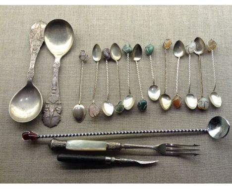 A SET OF TWELVE WHITE METAL SPOONS With various stone finials and large twizzle sticks, to include a pair of Austrian spoons,