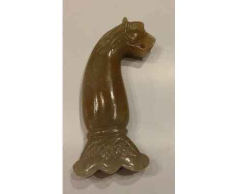 A MONGOLIAN JADE DAGGER HANDLE  Carved with a lion's head.