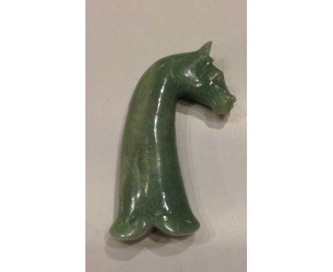 A MONGOLIAN JADE DAGGER HANDLE Carved with a horse's head with a flowing mane, parted to left.  (approx 13½cm)