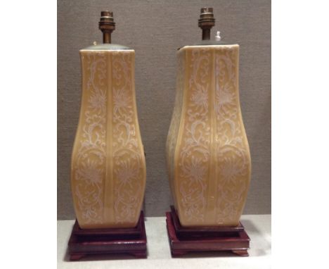 A PAIR OF 20TH CENTURY CHINESE PORCELAIN VASES Decorated in relief with white floral designs on yellow grounds, raised on squ