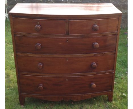 AN EARLY VICTORIAN MAHOGANY BOW FRONTED CHEST  Of two short above three long drawers, fitted with wooden knob handles above a