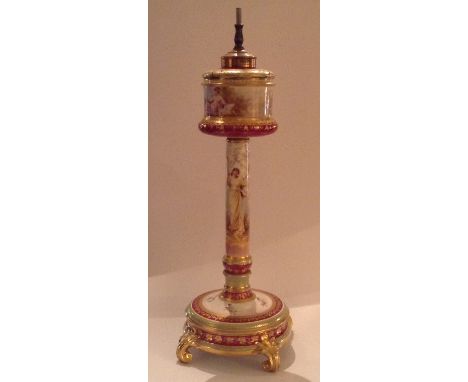 A 19TH CENTURY AUSTRIAN ROYAL VIENNA LAMP BASE Painted with classical scenes, having gilded brass fittings and bearing a blue