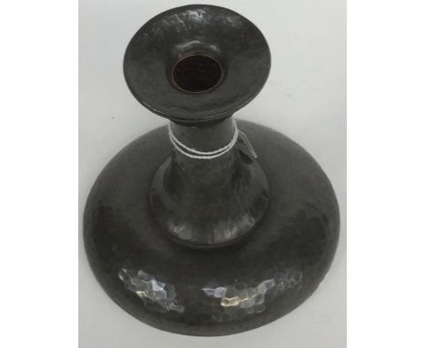 A Liberty Tudric Arts & Crafts pewter candlestick, hammered circular form, 01313, stamped marks, 12 cm high approx 